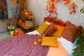 Cozy bedroom interior inspired by autumn colors with decor and pumpkins Royalty Free Stock Photo