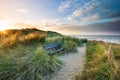 Cozy bench view view on sea beach at sunrise Royalty Free Stock Photo