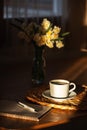 Cozy breakfast with cup of coffee, flowers and open notebook on rustic wooden table. Royalty Free Stock Photo