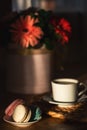 Cup of coffee on wooden table, vase with flowers. Royalty Free Stock Photo