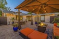 Cozy brick patio of a home with colorful seating area under a pavilion Royalty Free Stock Photo