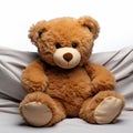 Cozy brown teddy rests on white, ready for your affection