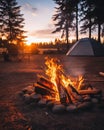 Camp fire at a campsite with two tents in the background