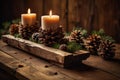 Cozy candlelit holiday display with pine cones and christmas decor Royalty Free Stock Photo