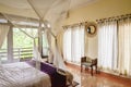 Cozy canopy bed in bedroom with balcony