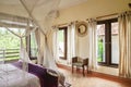 Cozy canopy bed in bedroom with balcony