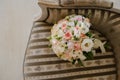 Cozy chair in the photo studio with wedding decoration and flowers bouqet