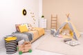 Cozy child room interior with bed, play tent