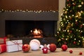 Cozy Christmas atmosphere with angel, decorations and gifts on wooden table in the foreground. In the background blurred the Royalty Free Stock Photo