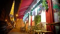 Cozy Christmas atmosphere in night Paris, view from street cafe at Eiffel Tower