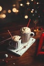 Cozy Christmas composition.Two mug with hot drinks, chocolate with whipped cream and cappuccino with cinnamon stick on a