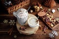 Cozy Christmas composition.Two mug with hot drinks, chocolate with whipped cream and cappuccino with cinnamon stick on a