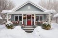 Cozy christmas cottage with festive decorations and delicate wreath in snowy surroundings