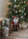 Cozy Christmas home interior. Christmas tree with decor, bench with basket, blankets and pillows. Christmas mood Royalty Free Stock Photo