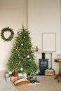 Cozy Christmas interior of the living room with a fireplace and a Christmas tree Royalty Free Stock Photo