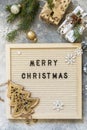 Cozy Christmas mood. Merry Christmas lettering on letter board, gifts boxs and holidays decorations. Winter seasons greeting card Royalty Free Stock Photo