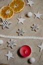 Cozy Christmas and New Year`s mood with copy space. Festive background with dried orange slices, candle, soft balls, decorative Royalty Free Stock Photo