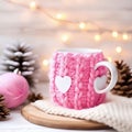 Cozy Christmas scenery with a white mug wearing a charming knitted handmade case Royalty Free Stock Photo