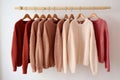 Cozy comfortable fashionable wardrobe, knitted cardigans hanging on a hanger