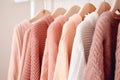Cozy comfortable pink fashionable wardrobe, knitted cardigans hanging on a hanger