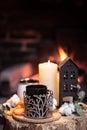 Cozy composition with a cup, candle and tangerines on a blurred background Royalty Free Stock Photo