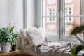 Cozy corner for reading books on windowsill in nordic style room Royalty Free Stock Photo