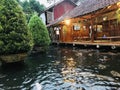 A cozy corner restaurant above a fish pond