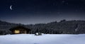 Cozy cottage in wintertime at night Royalty Free Stock Photo