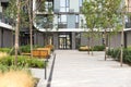 cozy courtyard with benches, trees near the high-rise city house