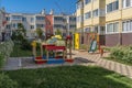 Cozy courtyard with green plants and attractions for children. A wonderful space for outdoor recreation among conifers