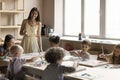 Multiethnic children attend art class led by young artist woman Royalty Free Stock Photo