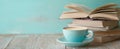 The cozy cup of coffee beside a stack of books on a wooden table. AI generated image Royalty Free Stock Photo