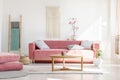 Cozy cushions and stylish textiles in a sunny, feminine living r