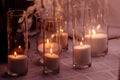 Cozy decor with candles burning in glass flasks Royalty Free Stock Photo