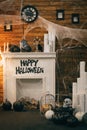 Cozy decorations in the interior for Halloween with a fireplace and festive attributes. Photozone for Halloween. Background