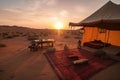 cozy desert camp, with view of surreal and otherworldly sunset mirage