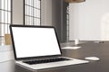 Cozy designer desktop with blank laptop screen