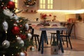 Cozy dining room interior with Christmas tree and beautiful festive decor Royalty Free Stock Photo