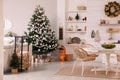 Cozy dining room interior with Christmas tree and festive decor Royalty Free Stock Photo