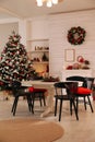 Cozy dining room interior with Christmas tree and festive decor Royalty Free Stock Photo