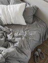 Cozy disassembled bed with gray linen. Interior bedroom Royalty Free Stock Photo