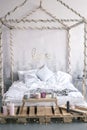 Cozy empty bed in studio room with wooden decor a word