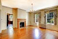 Cozy empty living room with fireplace and hardwood floor. Royalty Free Stock Photo