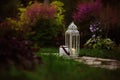 Cozy evening garden scene with vintage lantern and candle holder Royalty Free Stock Photo