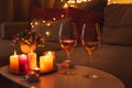 Cozy evening scene with candles, wine glasses and warm lighting Royalty Free Stock Photo