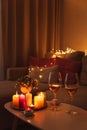 Cozy evening scene with candles, wine glasses and warm lighting Royalty Free Stock Photo