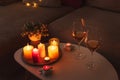 Cozy evening scene with candles, wine glasses and warm lighting Royalty Free Stock Photo