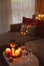 Cozy evening scene with candles, wine glasses and warm lighting Royalty Free Stock Photo