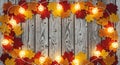 Cozy fall background with leaves and rustic string lights Royalty Free Stock Photo