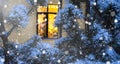 Cozy festive window of the house outside with the warm light of fairy lights garlands inside - celebrate Christmas and New Year in Royalty Free Stock Photo